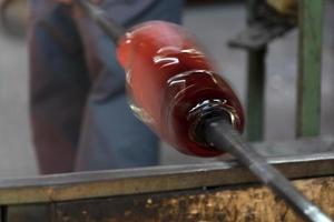 glass master while working in Murano furnace glass factory Venice Italy photo