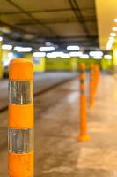 orange security bollard in underground parking photo