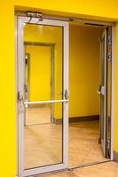 open doors and yellow walls at exit in house photo