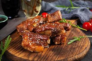 Grilled sliced ribs in sweet and sour sauce. Ribs marinated in honey sauce with herbs photo