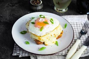 Delicious breakfast. Hot french toast with ham and bechamel sauce - croque madame photo
