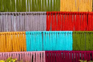 Many of the threads that are dyed brightly are the ones that have been prepared for the traditional loom because the fabric woven on the traditional loom is handmade and expensive. photo