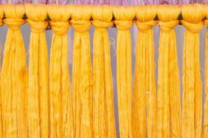 Many of the threads that are dyed brightly are the ones that have been prepared for the traditional loom because the fabric woven on the traditional loom is handmade and expensive. photo