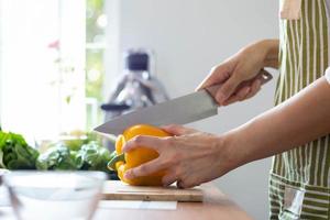 young woman preparing bell Pepper as a breakfast ingredient and ready for healthy cooking and on the table there are vegetables that are healthy organic ingredients. healthy food preparation ideas photo