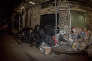 NEW YORK CITY - JUNE 16 2015 Garbage on the street at night photo