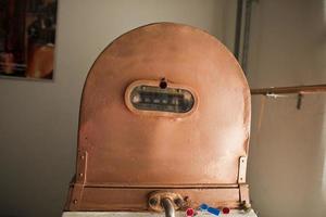 Copper still alembic inside distillery photo