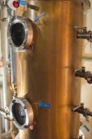 Copper still alembic inside distillery photo