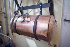 Copper still alembic inside distillery photo