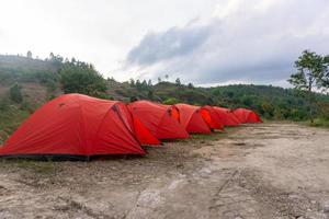 Camp tent area on the mountain. Red tents at the campsite. tourism concept. photo