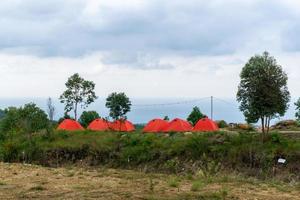 Camp tent area on the mountain. Red tents at the campsite. tourism concept. photo