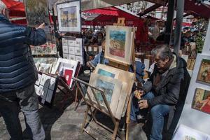 PARIS, FRANCE - MAY 1 2016 - Artist and tourist in Montmartre photo