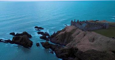 Aerial view of the ruins ancient Donator Castle in Scotland video