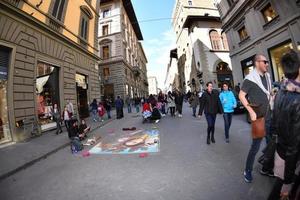 FLORENCE, ITALY - MARCH 27 2017 - Pavement artist painting on the streets photo