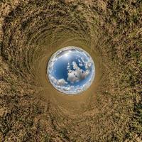 blue hole sphere little planet inside green grass round frame background. photo