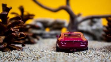 Minahasa, Indonesia  saturday, December 2022, a toy car among the pinecones photo