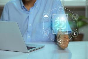 Using fingerprint scanning, the businessman accesses and unlocks the cloud data network. Cyber security and biometric identification protect business transactions from online cyber attacks photo