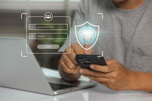 User uses fingerprint for log in for privacy and security of personal data. Cyber security protects business transactions from online cyberattacks photo