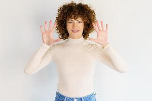 Smiling woman showing palms in studio photo