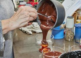 Chef pours the Pesach Special Chocolate Cream with Strawberries and Blueberries into special bowl photo