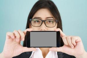 Young women in suit holding her smartphone photo