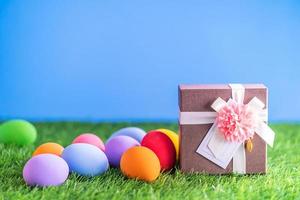 Easter eggs on grass and gift box photo