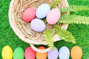 Easter eggs in the basket on grass photo