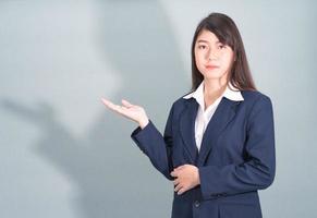 Woman in suit open hand palm gestures with empty space photo