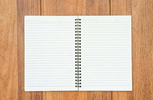 Top view image of open notebook with blank pages on wooden table photo