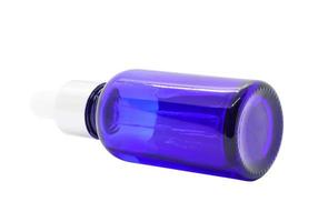 Blue glass dropper serum bottle on white background photo