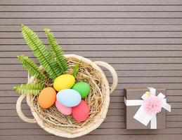 Easter eggs in the basket and gift box photo