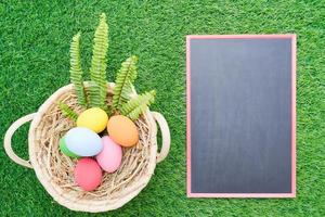 cierra los huevos de pascua en la maqueta de hierba y pizarra foto