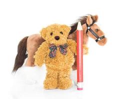 Teddy bear with red pencil and horses photo