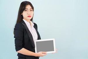 Young women in suit holding her digital tablet photo