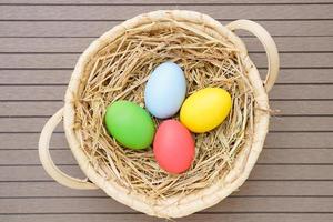 close up Easter eggs in the basket on wood photo