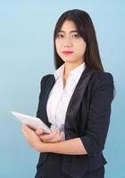 Women standing in suit holding digital tablet photo