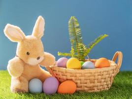 Bunny toy and Easter eggs in basket photo