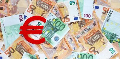 Banner with red felt Euro currency symbol on 50 and 100 euro banknotes background. Financial, bank, money, economy, business concept. Place for text. photo