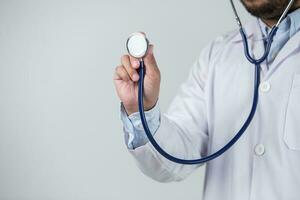 male doctor is holding stethoscope photo