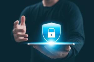Cybersecurity Privacy data protection concept, businessman holding key protect business and financial data with virtual network connection, security internet access, security encryption. photo