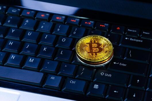 Bitcoin coins on compuer keyboard,symbol of electronic virtual money and mining cryptocurrency concept.Coin crypto currency bitcoin concept.Bitcoin on keyboard. photo