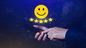 Customer services best excellent business rating experience, Positive Review and Feedback, Satisfaction survey concept. Hand of a businessman show happy smile face with five star. photo