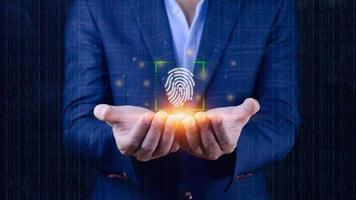 Businessman using showing scanning fingerprint, Biometric identity and authorization futuristic concept of password security and control through fingerprint in future. photo