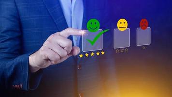 Businessman choosing happy smile face icon. feedback rating and positive customer review experience, satisfaction survey. mental health assessment. photo