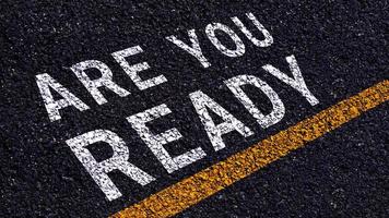 Are you ready written on the middle of the asphalt with yellow line road. Are you ready Write on the road in the middle of the empty asphalt road photo