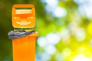 Orange Garbage bins on  nature green background photo