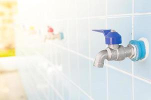 Colorful Faucet on a blue wall photo