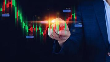 Hand of businessman or trader is touching growing virtual hologram stock, planning and strategy, Stock market, Business growth, progress or success concept. invest in trading. photo