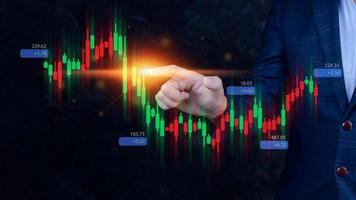 Hand of businessman or trader is touching growing virtual hologram stock, planning and strategy, Stock market, Business growth, progress or success concept. invest in trading. photo