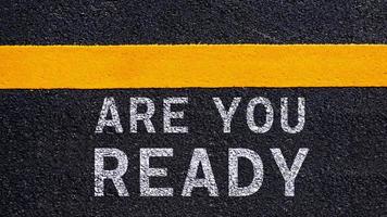 Are you ready written on the middle of the asphalt with yellow line road. Are you ready Write on the road in the middle of the empty asphalt road photo