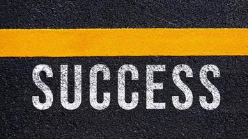 Success text written on road concept for business planning strategies and challenges or career path opportunities and change, road to success concept, Success word on street photo